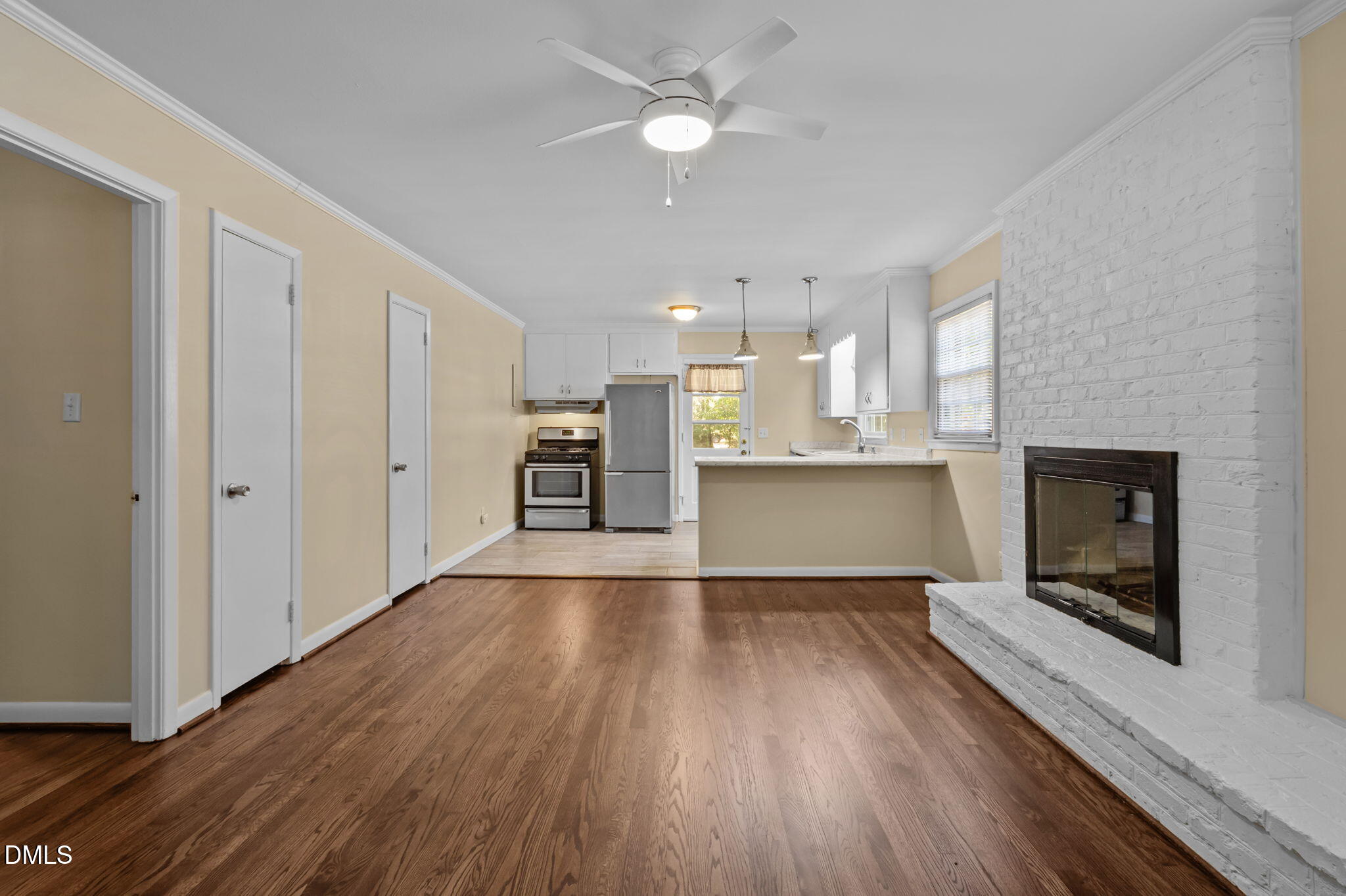 200 Davie Road, Unit A&B Carrboro, NC 27510 - Photo 3 of 36 a view of a kitchen and an empty room with wooden floor a fireplace