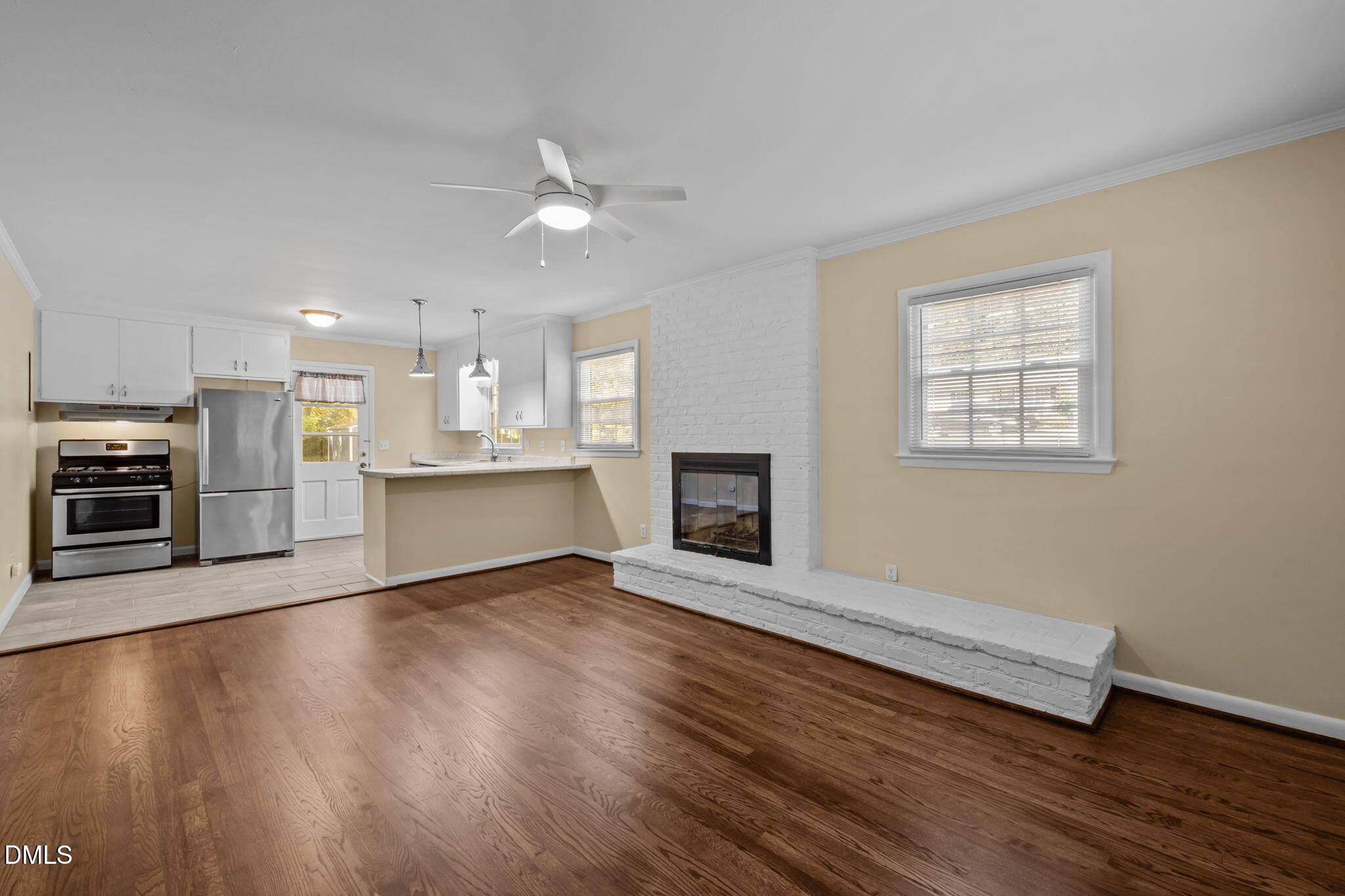 200 Davie Road, Unit A&B Carrboro, NC 27510 - Photo 4 of 36 a view of an empty room with wooden floor and a kitchen