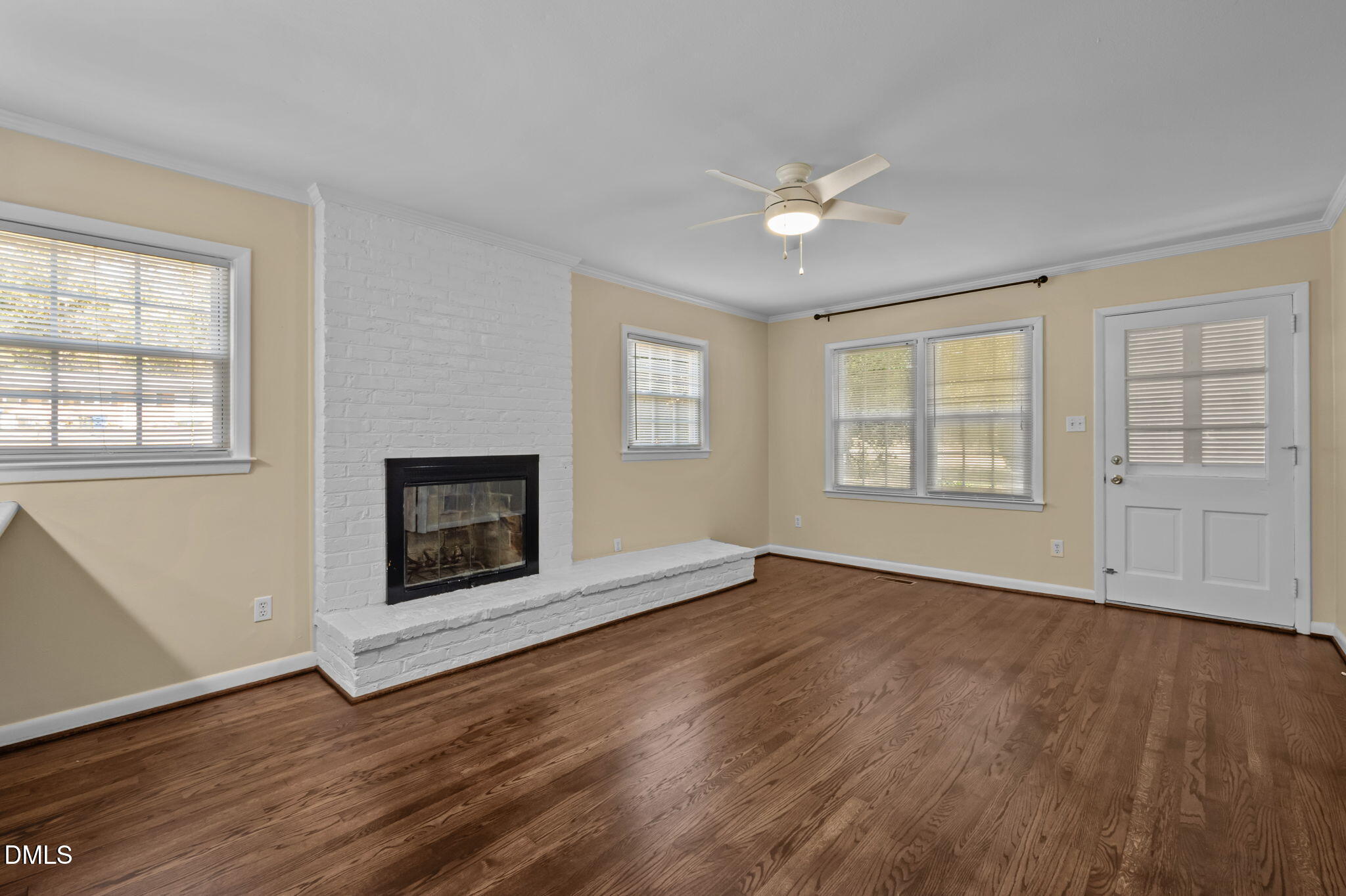 200 Davie Road, Unit A&B Carrboro, NC 27510 - Photo 5 of 36 an empty room with wooden floor a ceiling fan and windows