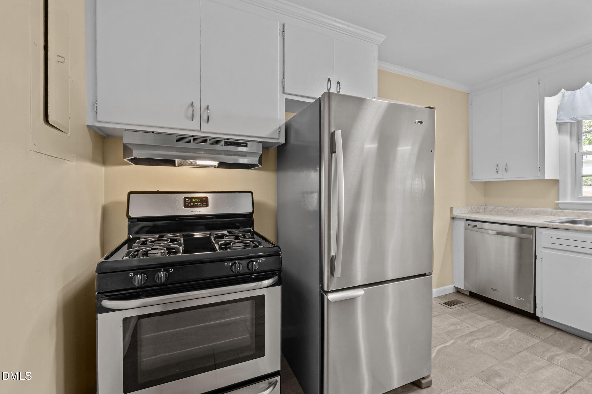 200 Davie Road, Unit A&B Carrboro, NC 27510 - Photo 8 of 36 a kitchen with refrigerator a stove and white cabinets