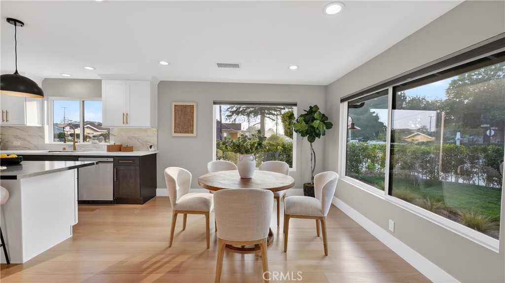 4404 Cogswell Road El Monte, CA 91732 - Photo 18 of 63 a kitchen with a table chairs stove and wooden floor