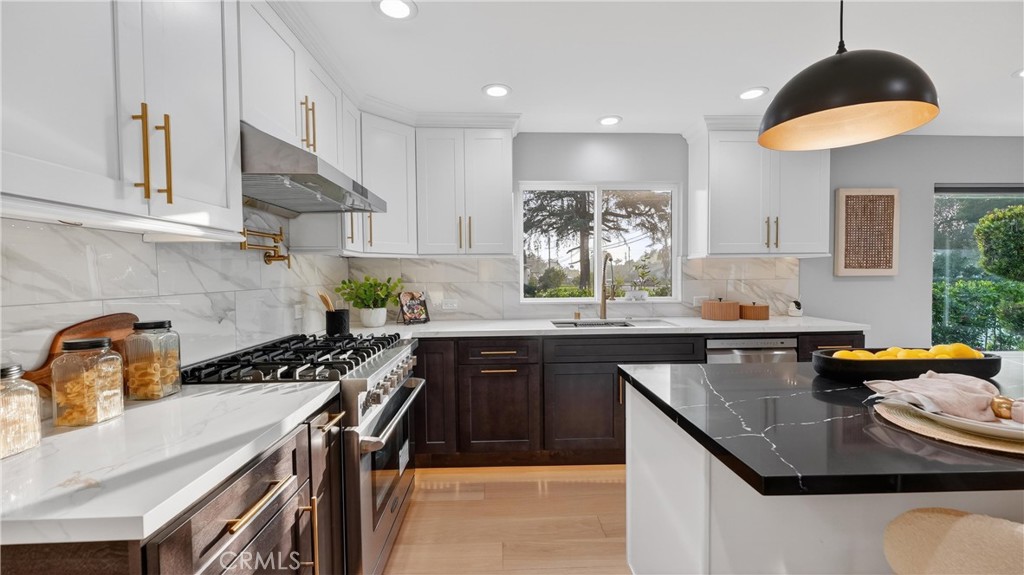 4404 Cogswell Road El Monte, CA 91732 - Photo 25 of 63 a kitchen with stainless steel appliances granite countertop a sink a stove and a refrigerator