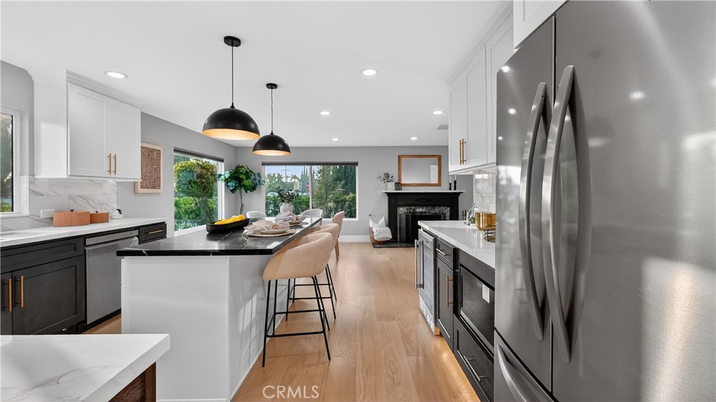 4404 Cogswell Road El Monte, CA 91732 - Photo 29 of 63 a kitchen with stainless steel appliances granite countertop a sink a stove and a refrigerator