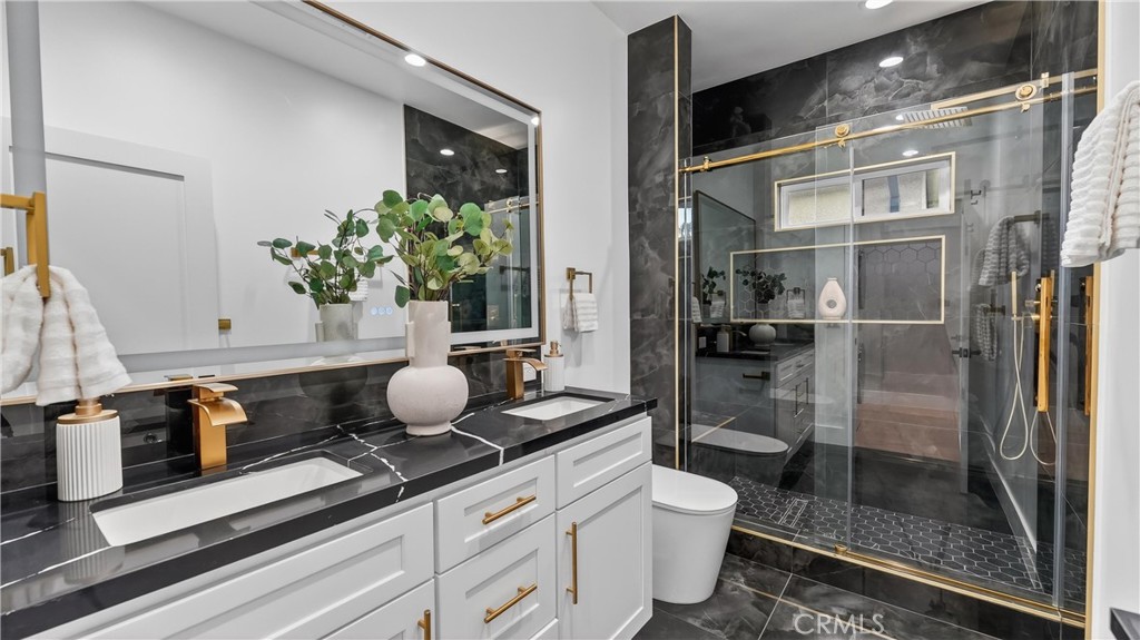 4404 Cogswell Road El Monte, CA 91732 - Photo 44 of 63 a bathroom with a granite countertop sink a toilet and shower