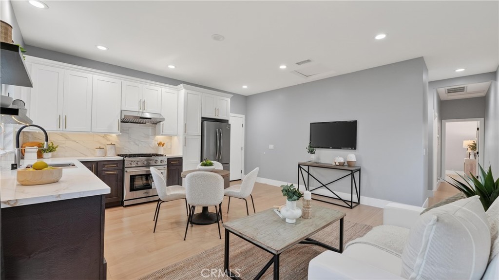 4404 Cogswell Road El Monte, CA 91732 - Photo 46 of 63 a living room with furniture a flat screen tv and kitchen view