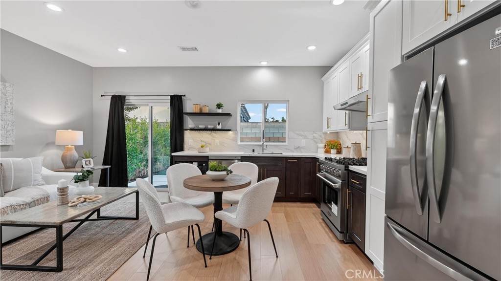 4404 Cogswell Road El Monte, CA 91732 - Photo 47 of 63 a kitchen with a table chairs refrigerator and microwave