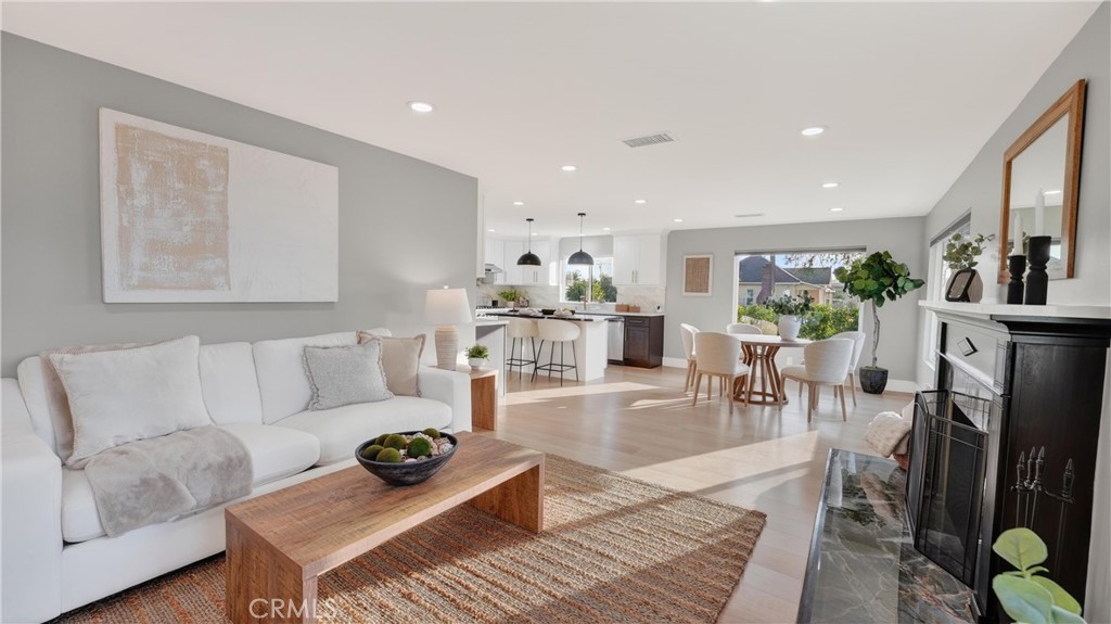 4404 Cogswell Road El Monte, CA 91732 - Photo 10 of 63 a living room with furniture a wooden floor and a fireplace