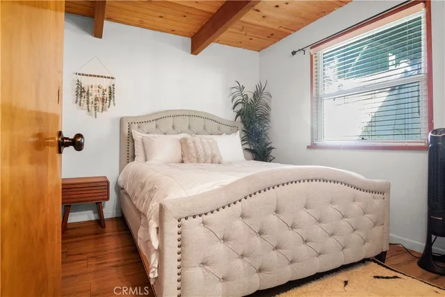 a large bed sitting in a bedroom next to a window