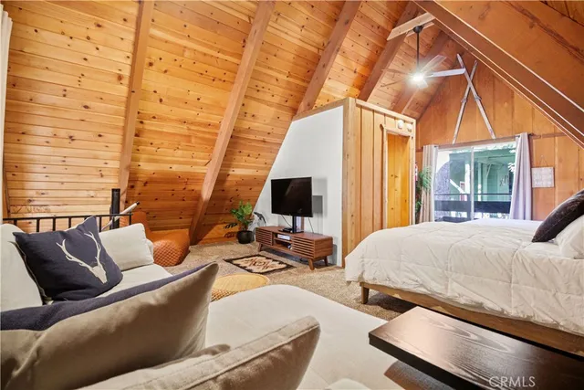 a bedroom with furniture and a flat screen tv