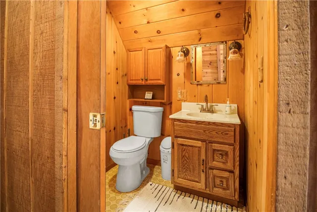 a bathroom with a granite countertop toilet and a sink
