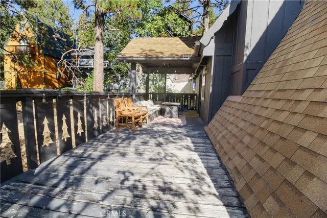 a view of a chairs and table in patio with wooden fence
