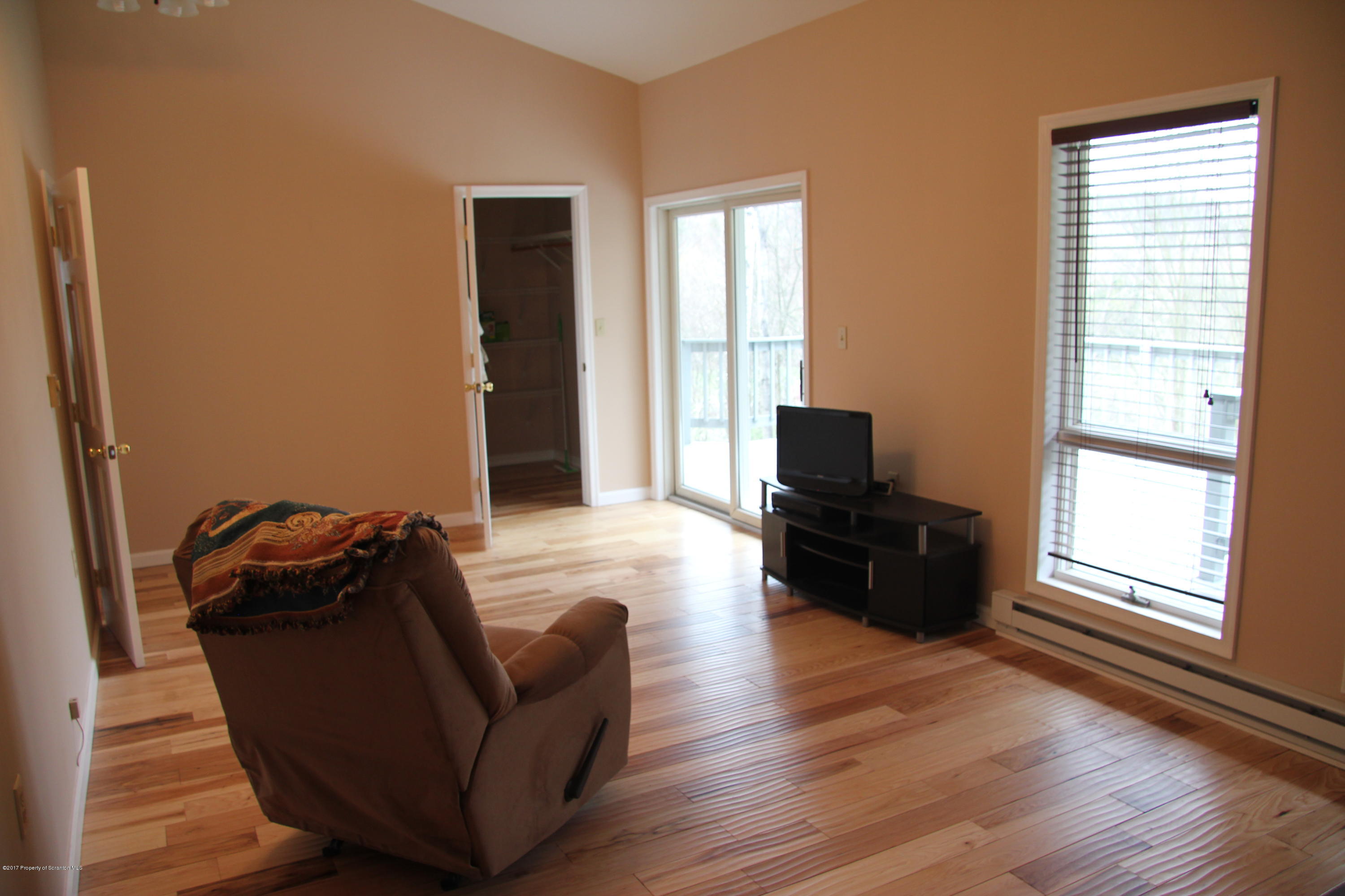 155 Blossom Road Nicholson, PA 18446 - Photo 12 of 35 a living room with furniture wooden floor and a window