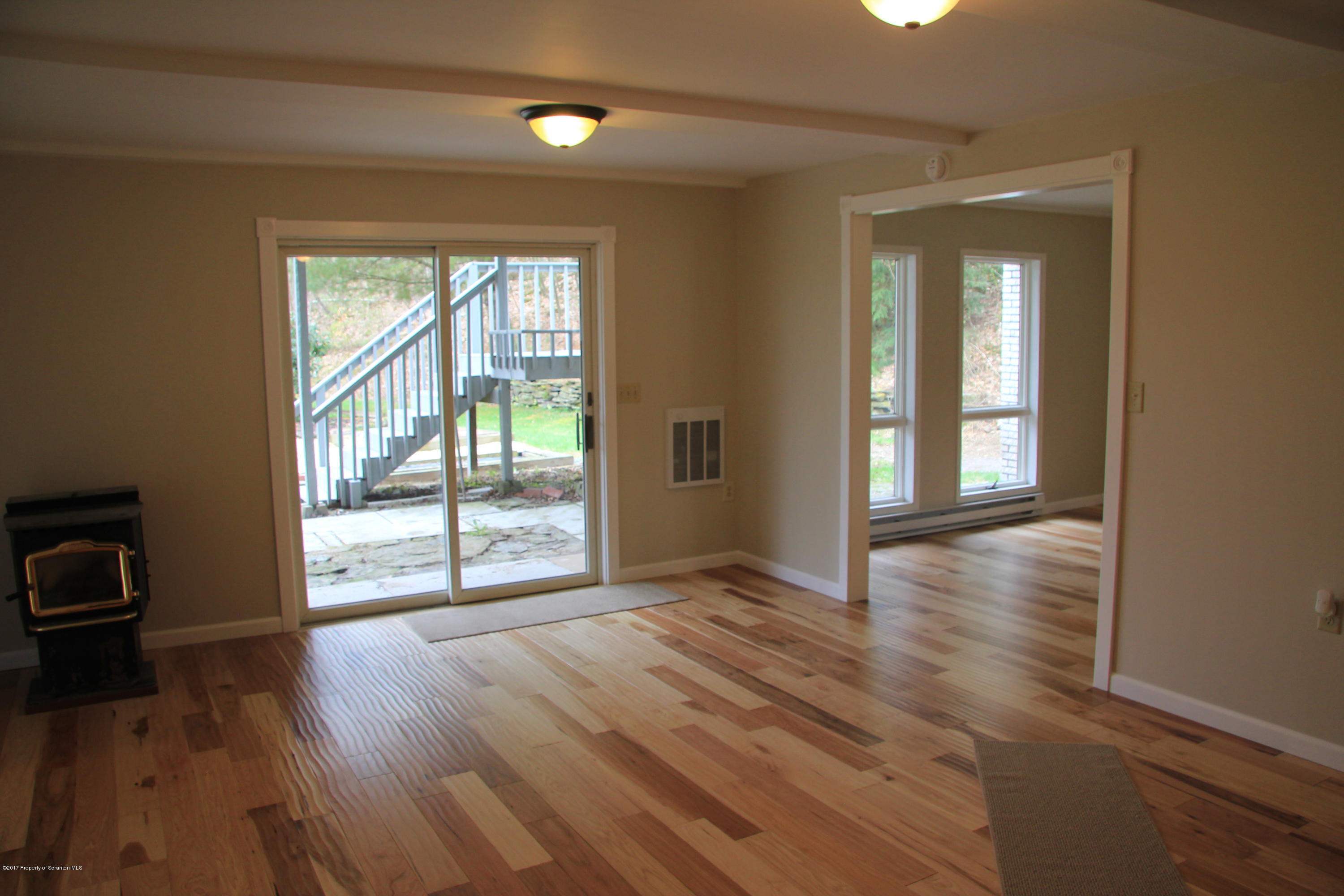 155 Blossom Road Nicholson, PA 18446 - Photo 4 of 35 a view of an empty room with wooden floor and a window