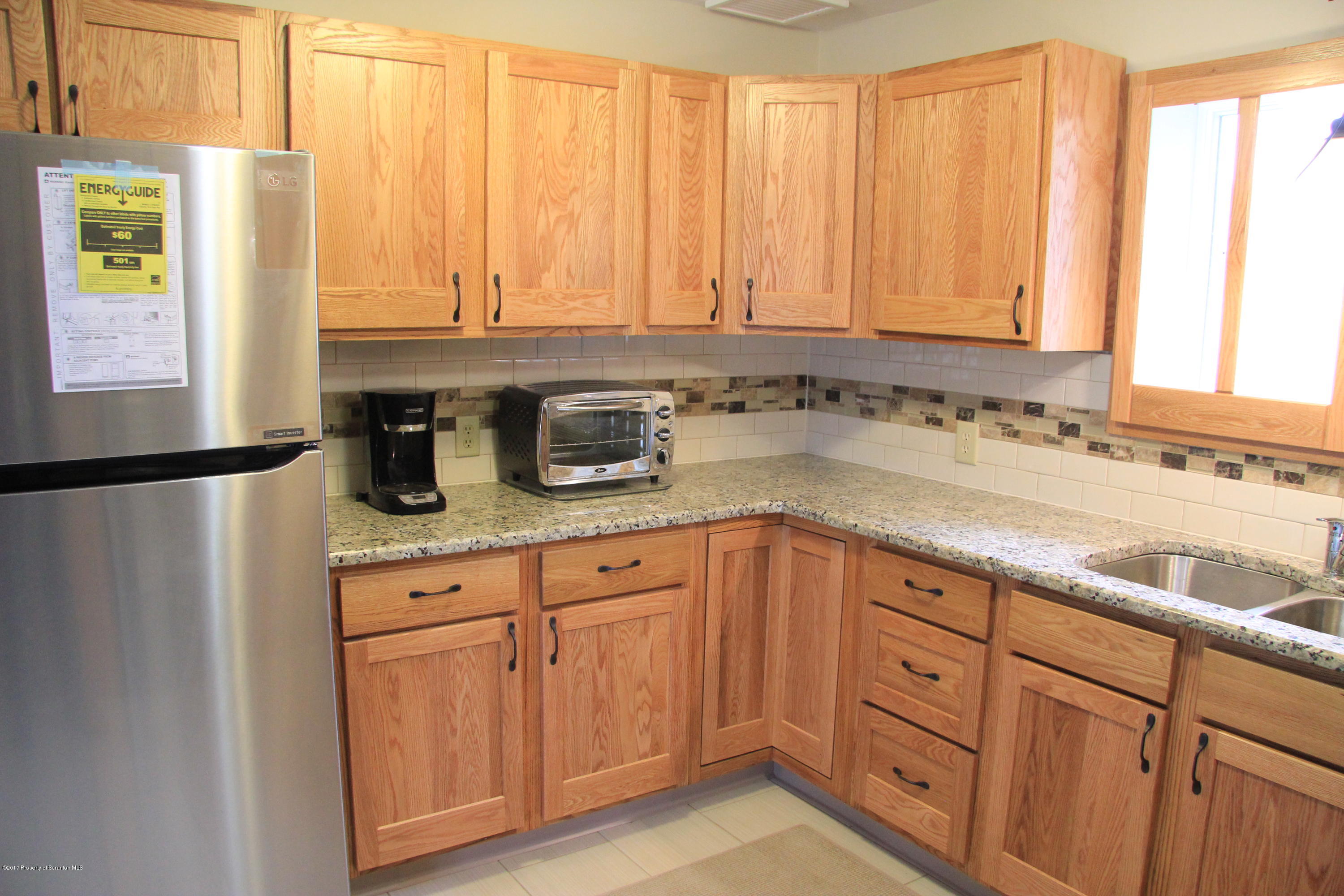 155 Blossom Road Nicholson, PA 18446 - Photo 5 of 35 a kitchen with stainless steel appliances granite countertop a sink a refrigerator and cabinets