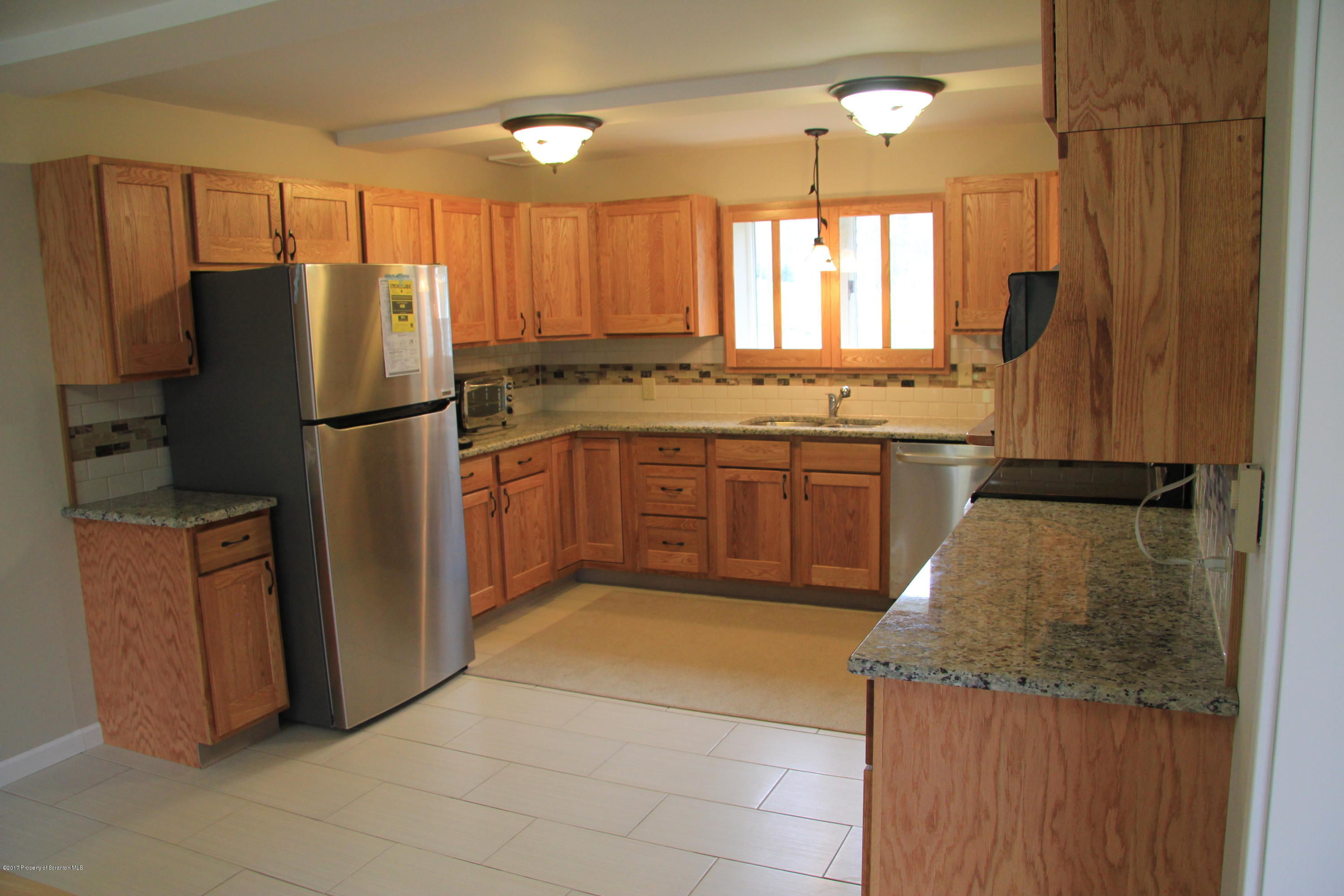 155 Blossom Road Nicholson, PA 18446 - Photo 6 of 35 a kitchen with stainless steel appliances granite countertop a refrigerator and a stove