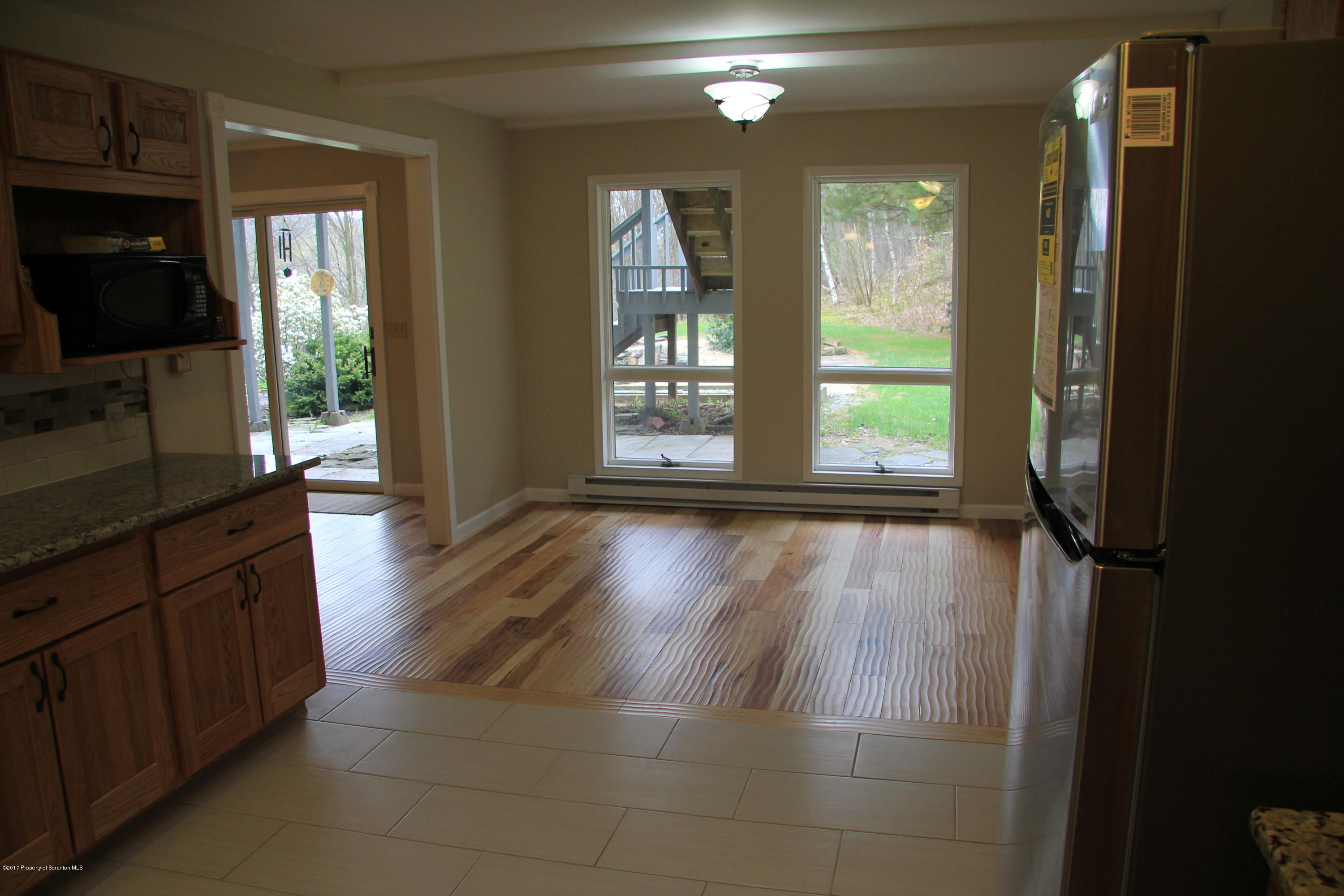 155 Blossom Road Nicholson, PA 18446 - Photo 10 of 35 a view of a hallway with wooden floor and a living room