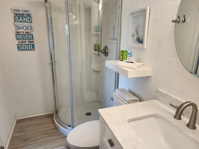 a bathroom with a sink toilet and shower