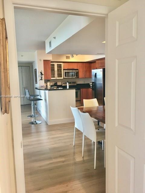 3232 Southwest 22nd Terrace, Unit 1303 Miami, FL 33145 - Photo 14 of 43 a kitchen with a table chairs and a view of kitchen