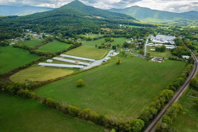 an aerial view of a houses with a yard