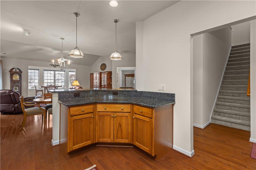 137 Freedom Lane Sewickley, PA 15143 - Photo 12 of 36 a open kitchen with a sink dishwasher a dining table and chairs with wooden floor