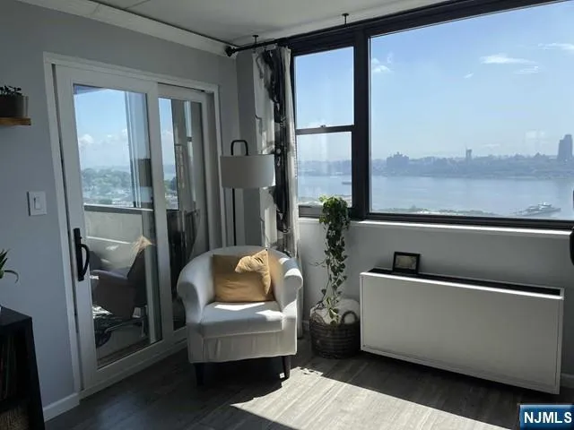 a living room with furniture and a floor to ceiling window
