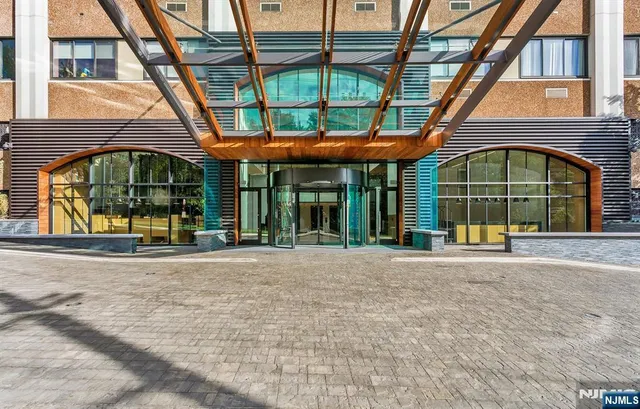 a view of large building with a big yard and large trees