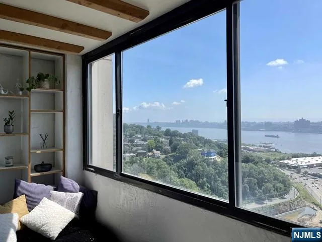 a view of a room with furniture and floor to ceiling window