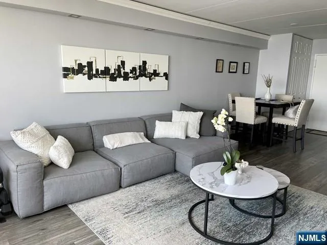 a living room with furniture and a dining table