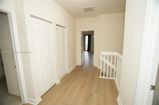 a view of a hallway with a white door