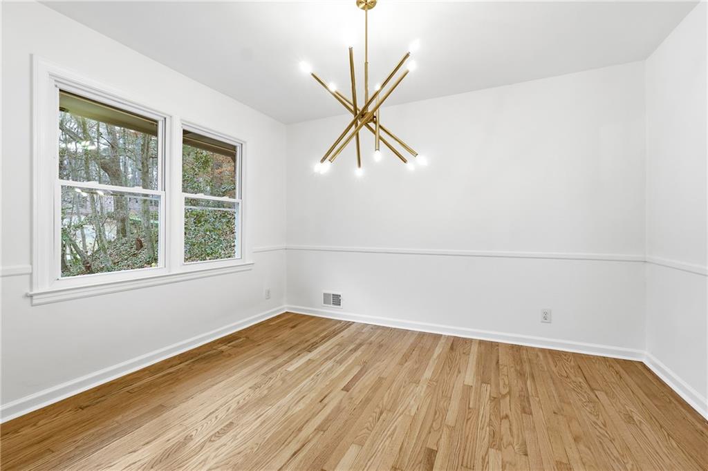 2520 Overlook Way Northeast Atlanta, GA 30345 - Photo 22 of 31 an empty room with a window and a wooden floor