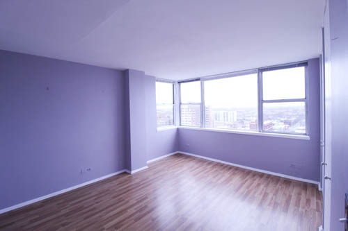 6301 North Sheridan Road, Unit 19A Chicago, IL 60660 - Photo 5 of 24 an empty room with wooden floor and windows