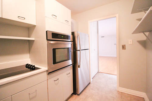 6301 North Sheridan Road, Unit 19A Chicago, IL 60660 - Photo 8 of 24 a kitchen with granite countertop white cabinets and stainless steel appliances