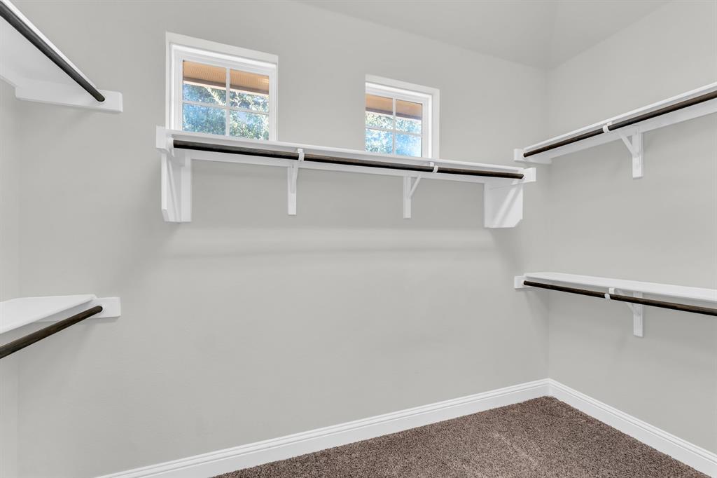 110 Magona Trail Georgetown, TX 78628 - Photo 34 of 38 Ample shelving and hanging space, plus dual windows, create a naturally illuminated and highly functional closet.