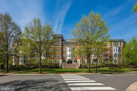 a view of a tall building next to a yard