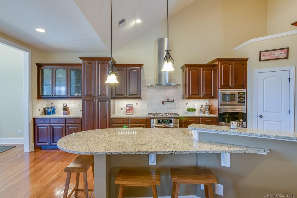 1770 Verdict Ridge Drive Denver, NC 28037 - Photo 12 of 36 a kitchen with stainless steel appliances granite countertop a kitchen island a stove and a sink