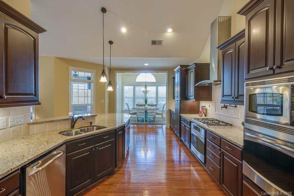 1770 Verdict Ridge Drive Denver, NC 28037 - Photo 14 of 36 a kitchen with stainless steel appliances granite countertop a sink stove and cabinets