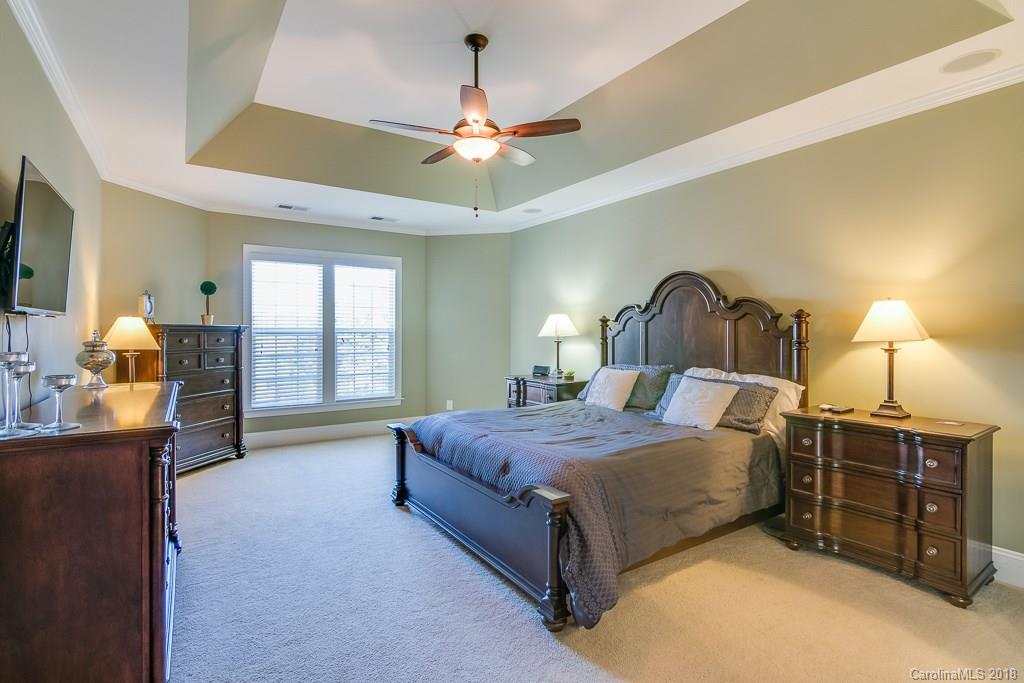 1770 Verdict Ridge Drive Denver, NC 28037 - Photo 18 of 36 a spacious bedroom with a bed and a chandelier