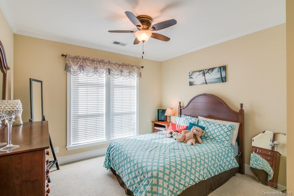 1770 Verdict Ridge Drive Denver, NC 28037 - Photo 22 of 36 a bedroom with a bed and a chandelier