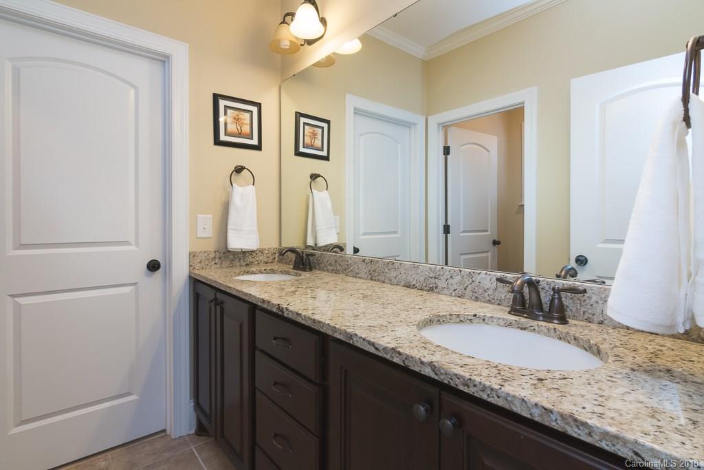1770 Verdict Ridge Drive Denver, NC 28037 - Photo 25 of 36 a bathroom with a granite countertop double vanity sink and a mirror