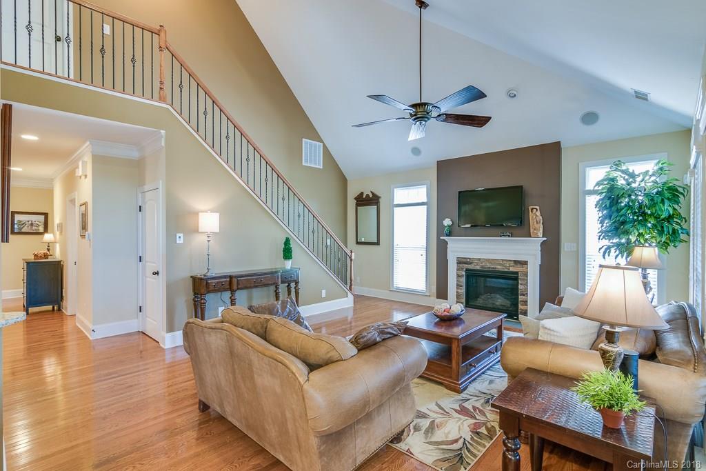 1770 Verdict Ridge Drive Denver, NC 28037 - Photo 8 of 36 a living room with furniture a fireplace and a flat screen tv
