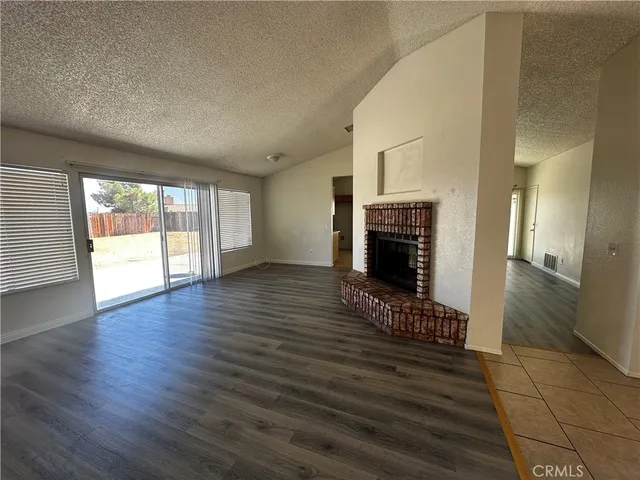 wooden floor in an empty room with a fireplace
