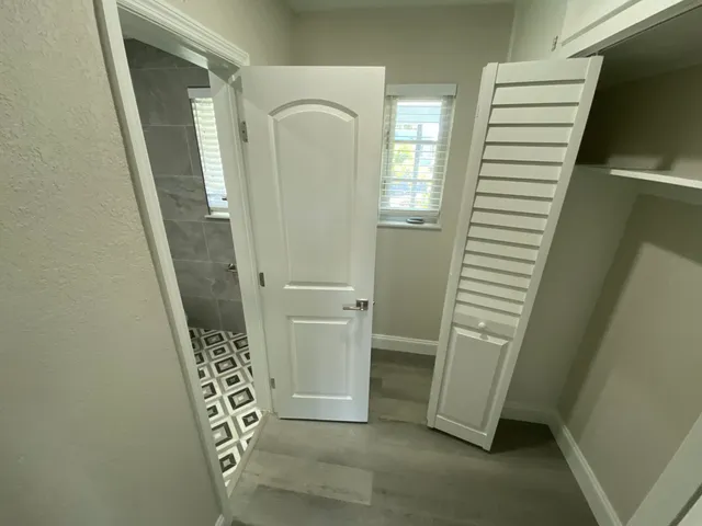 a bathroom with a toilet a sink and a mirror