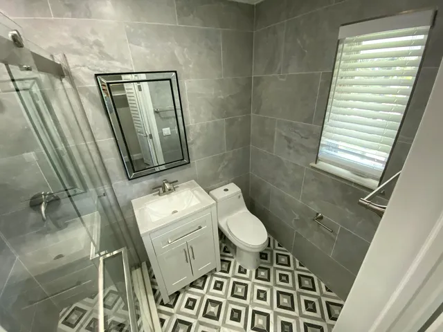 a bathroom with a sink toilet and shower