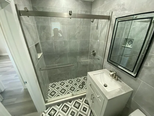 a bathroom with a sink toilet and shower