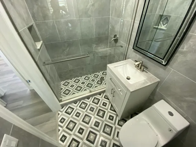 a bathroom with a toilet sink and mirror
