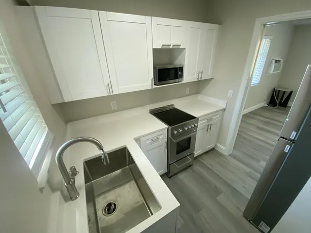 a view of a kitchen from a hallway