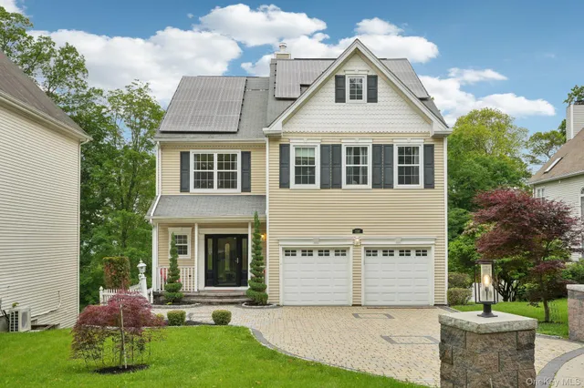 a front view of a house with a yard and garage