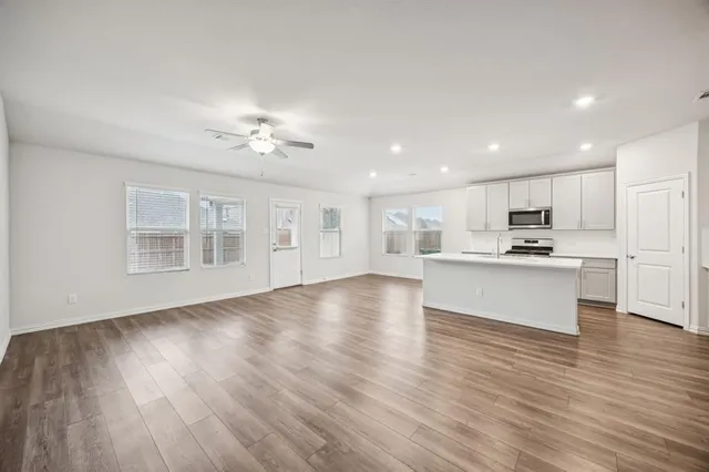 a view of kitchen with cabinets and wooden floor