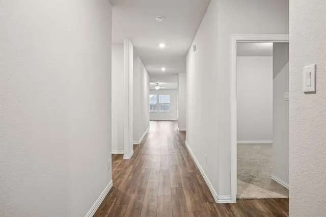 a view of a hallway with wooden floor