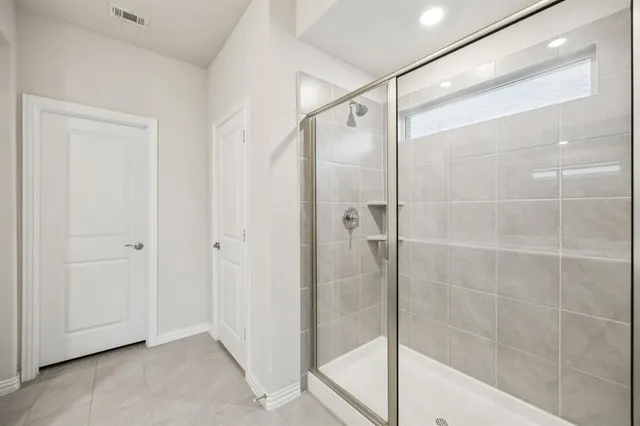 a bathroom with a glass shower door